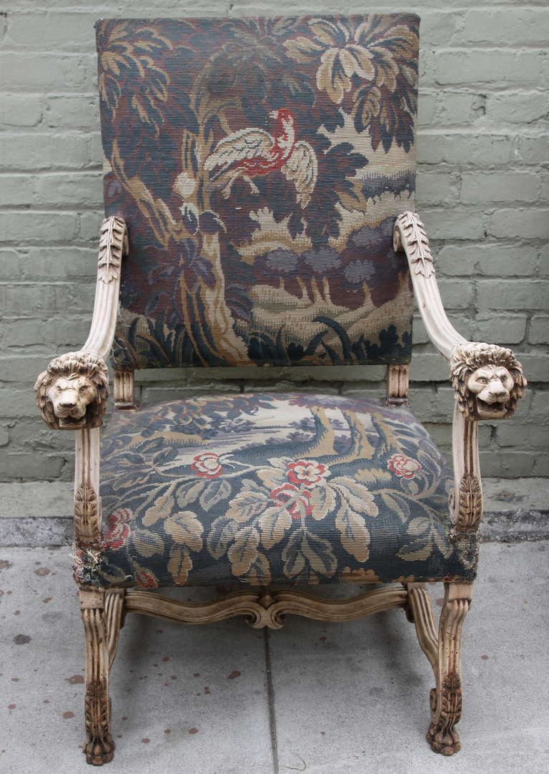 Pair of 19th Century Italian carved armchairs with original tapestry upholstery and lion faces at ends of arms.