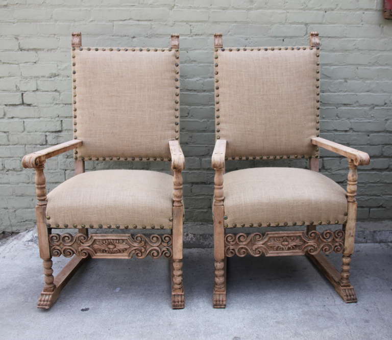Pair of Spanish carved burlap upholstered armchairs with spaced nailhead trim detail.