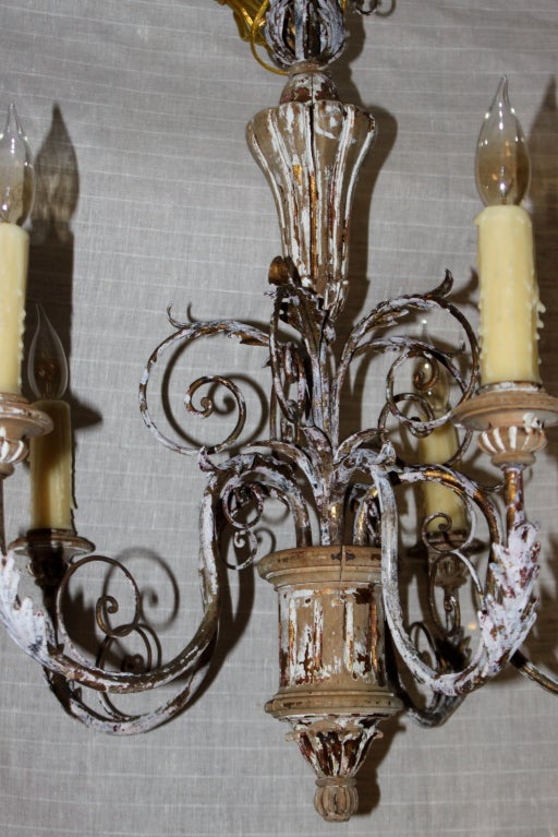 Italian carved wood painted and wrought iron chandelier that has been completely rewired with new sockets and wax candle covers.