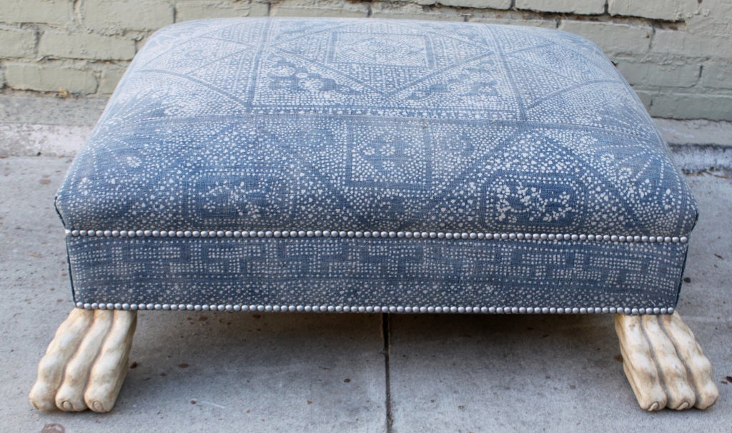 Vintage batik textile ottoman with antique ivory painted paw feet and pewter nailhead trim.