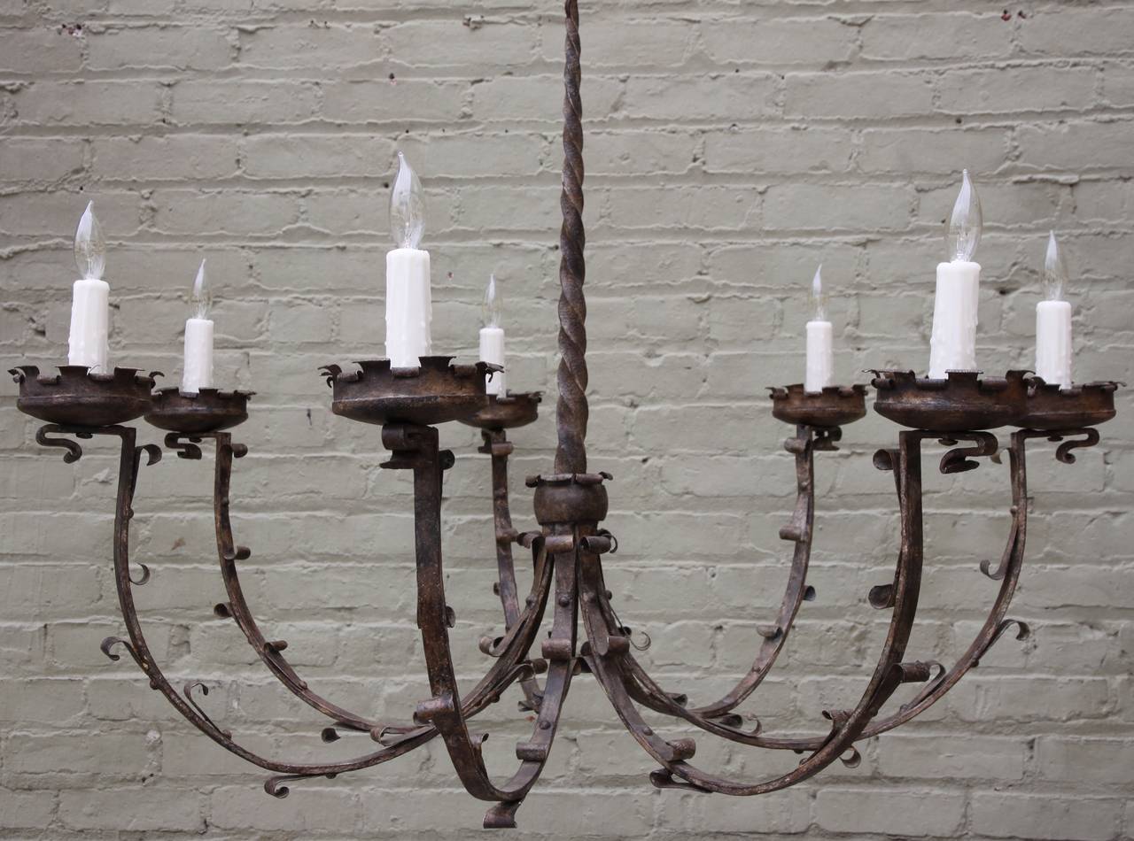 Spanish wrought iron seven arm chandelier that is newly wired with canopy and wax candle covers.