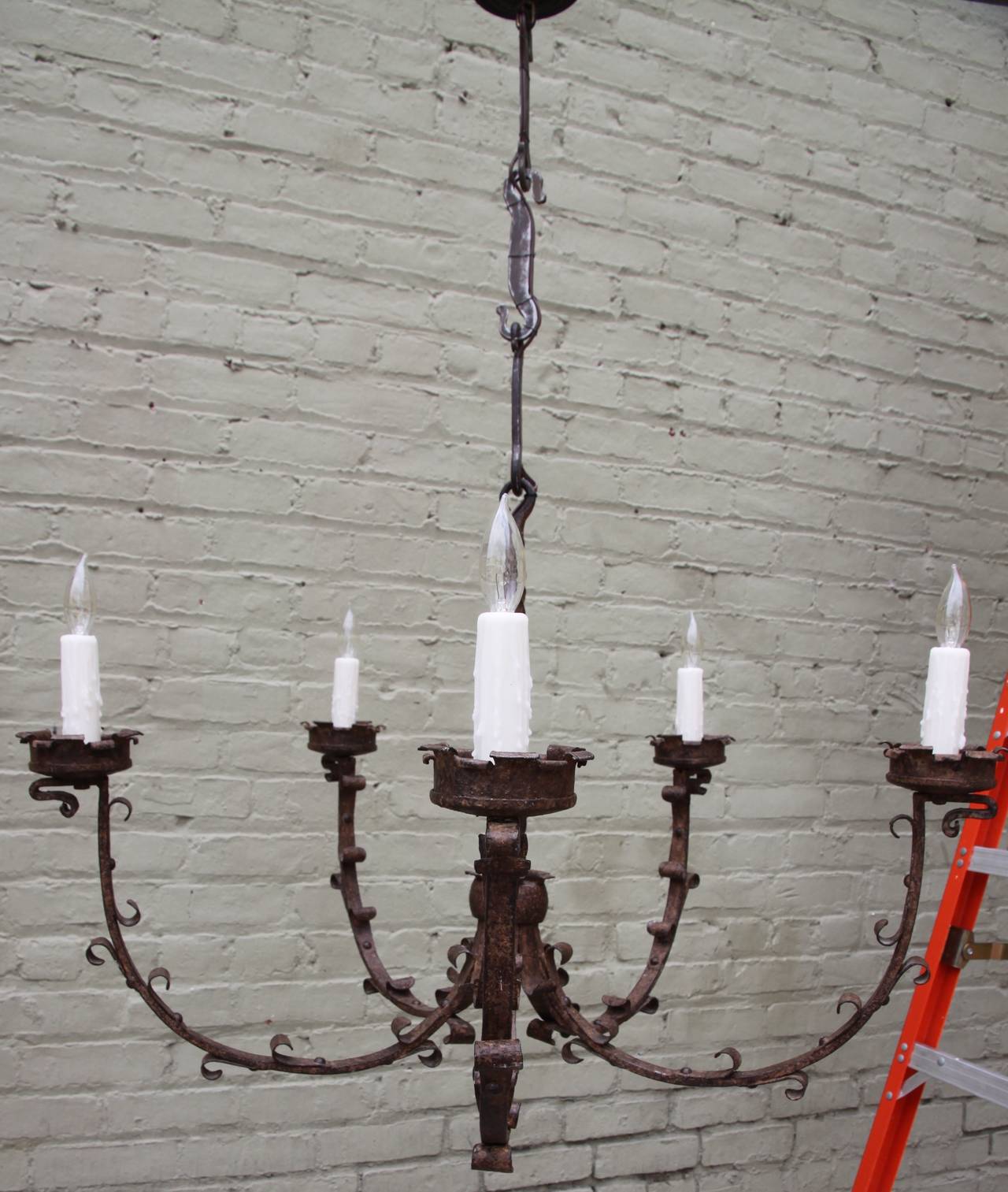 Spanish wrought iron five arm chandelier that is newly wired with chain and canopy included.