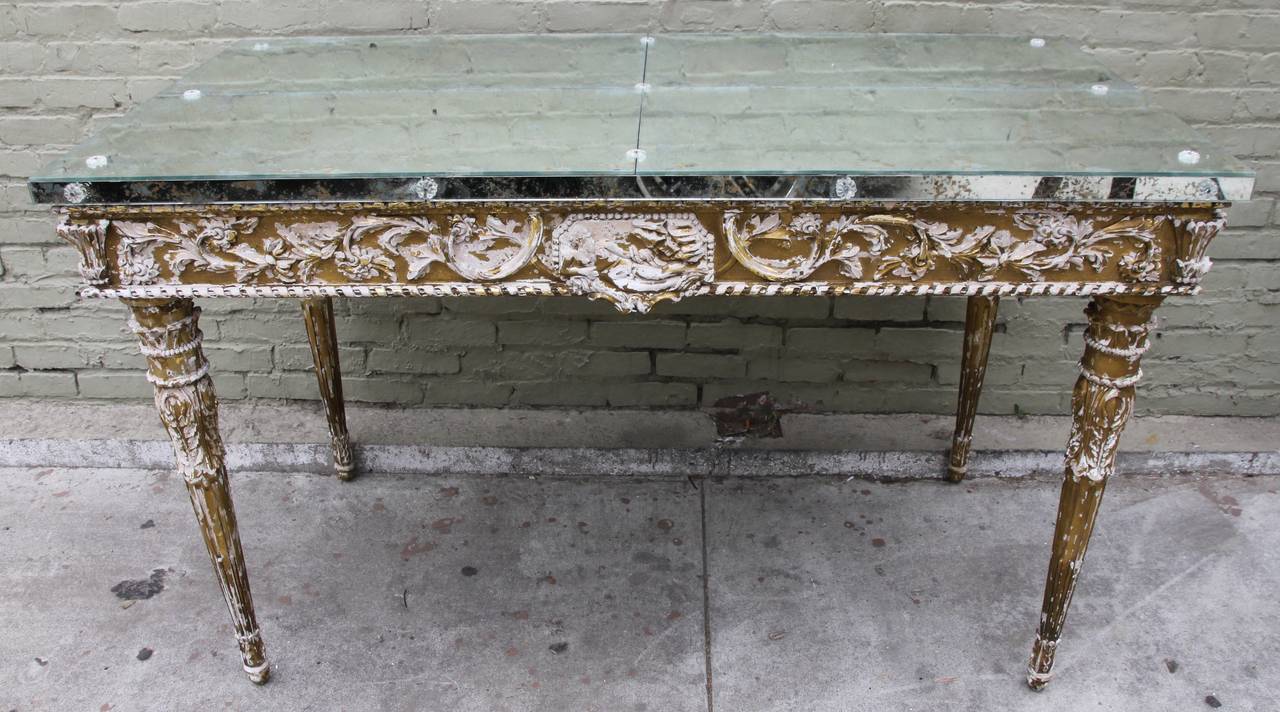 19th C. carved Italian Neoclassical style gilt wood console with antiqued mirrored top and crystal rosettes.  This great statement piece stands on four straight legs