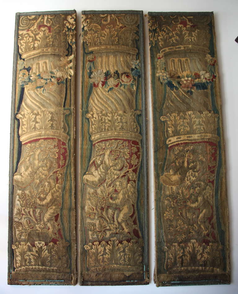 Set of three 18th century tapestry panels depicting Corinthian columns with cherubs & acanthus leaves throughout.