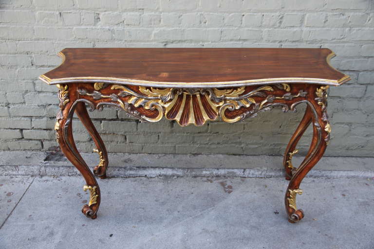 French carved rust painted console with gold & silver accents throughout.