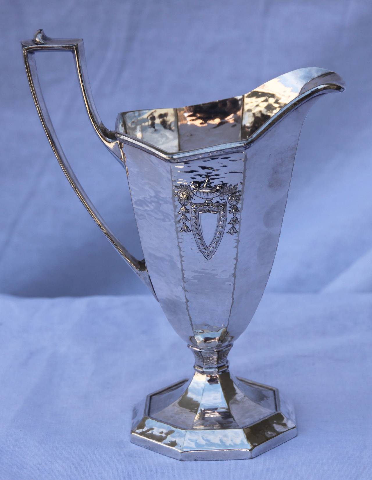 Hand-hammered and engraved tea set by Meriden Britannia Company, founded in 1852, acquired the Rogers Bros. MFG. Co. in 1862, became a subsidiary of International Silver Company in 1898. The tray has no hallmark.
