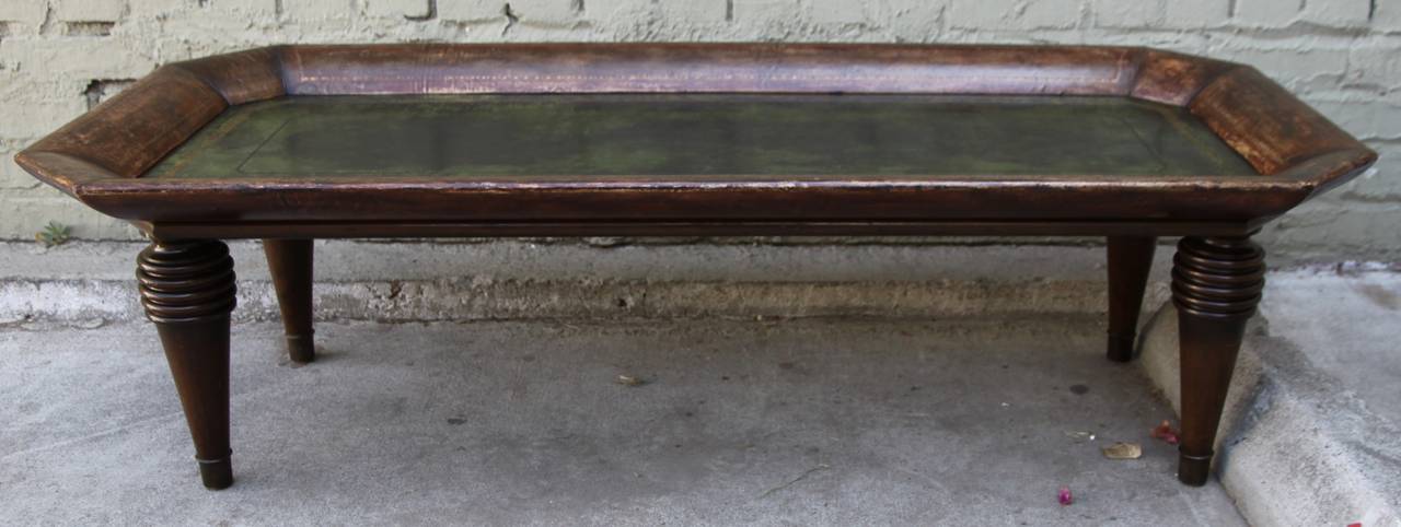 English gold embossed leather coffee table in beautiful worn shades of green and brown. The octagonal shaped top sits on four straight deco style carved legs.