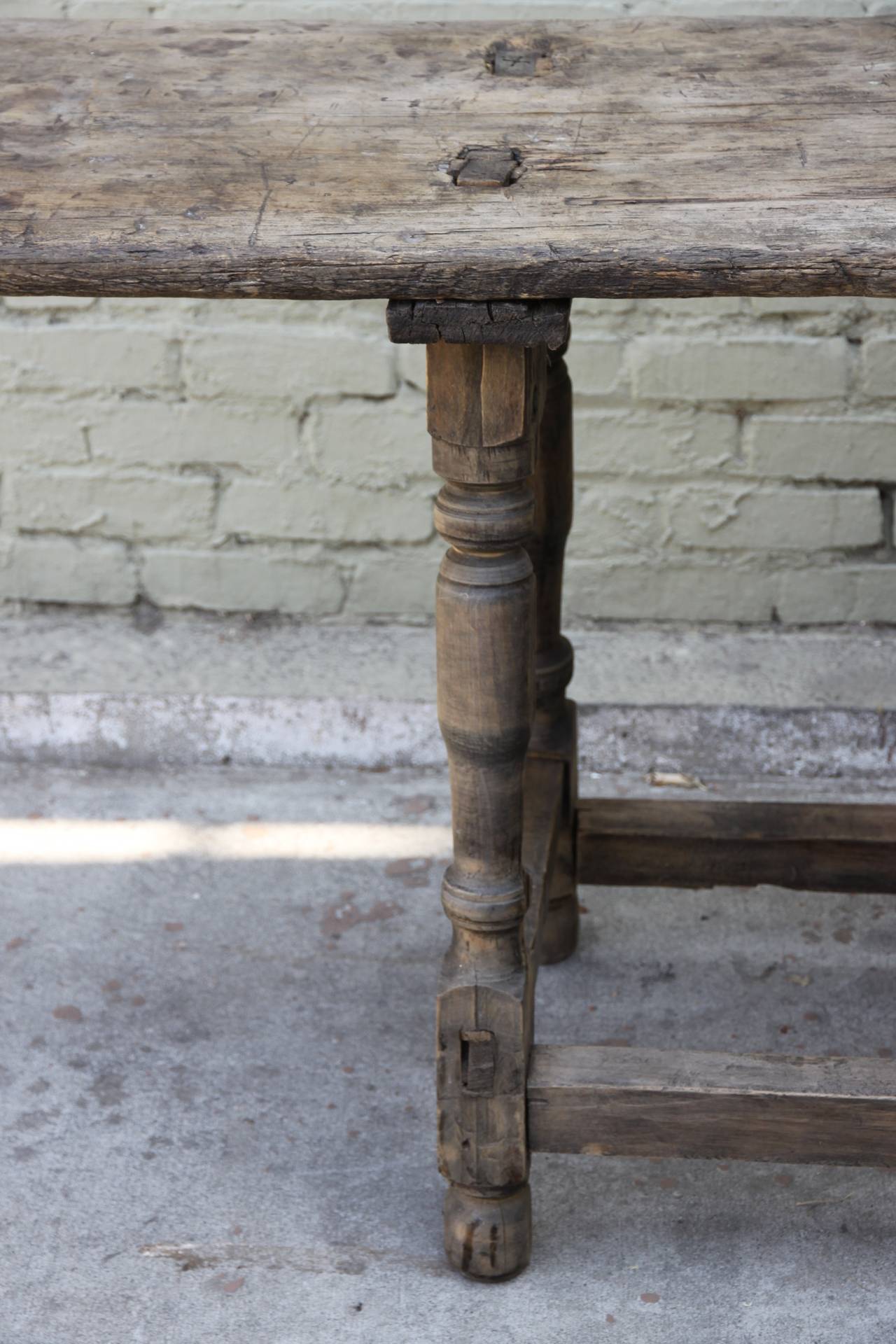 Antique Primitive work table standing on four legs with bottom stretcher.