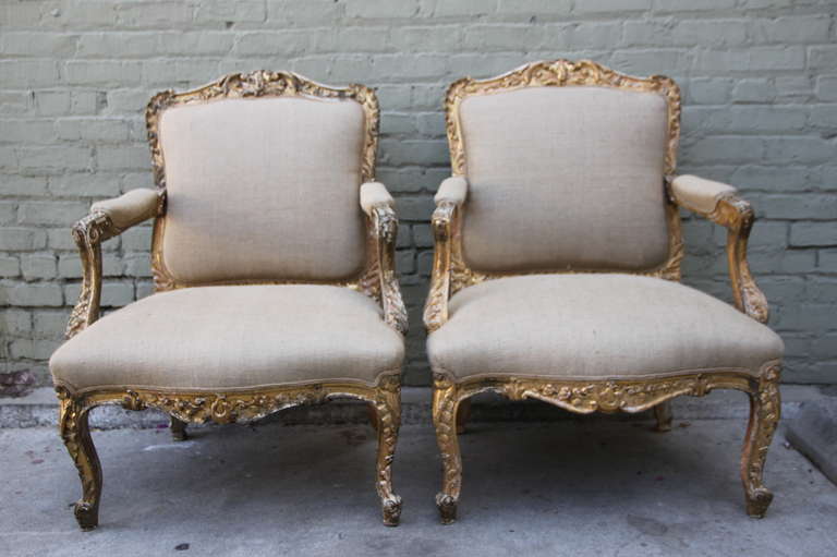 Pair of 19th century French Provincial style gilt wood armchairs newly upholstered in Belgium linen with double cord detail.