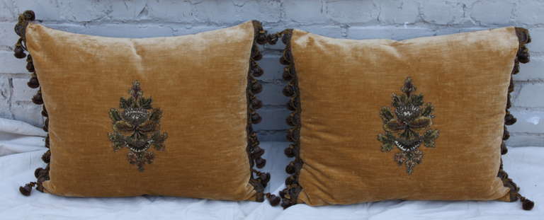 19th century French metallic and chenille appliqued linen velvet pillows with linen back and tassel fringe on both sides. Down inserts. Sewn closed.