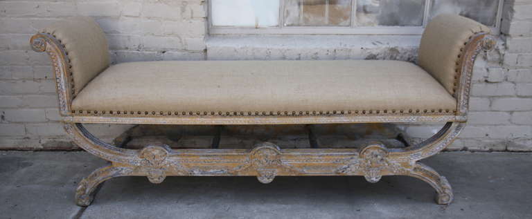 French carved wood painted bench newly upholstered in burlap with original nail head trim detail.