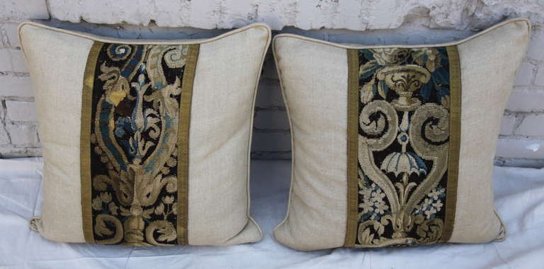 Pair of 18th century French tapestry pillows with linen backs and self cord detail. Down insets. Sewn shut.