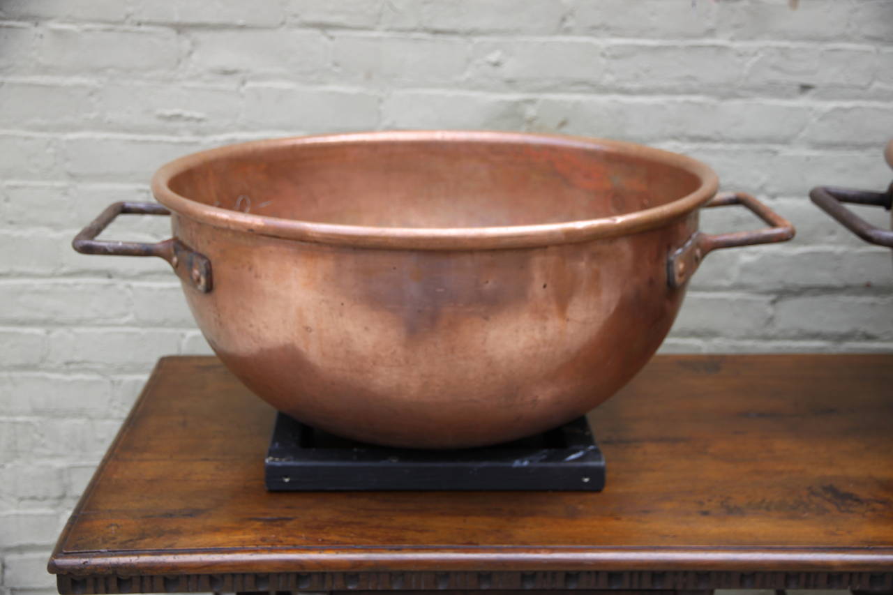 Pair of 19th century copper cooking vats for the making of candy originally. Hallmarked by American copper maker, T. Burkhard Inc.