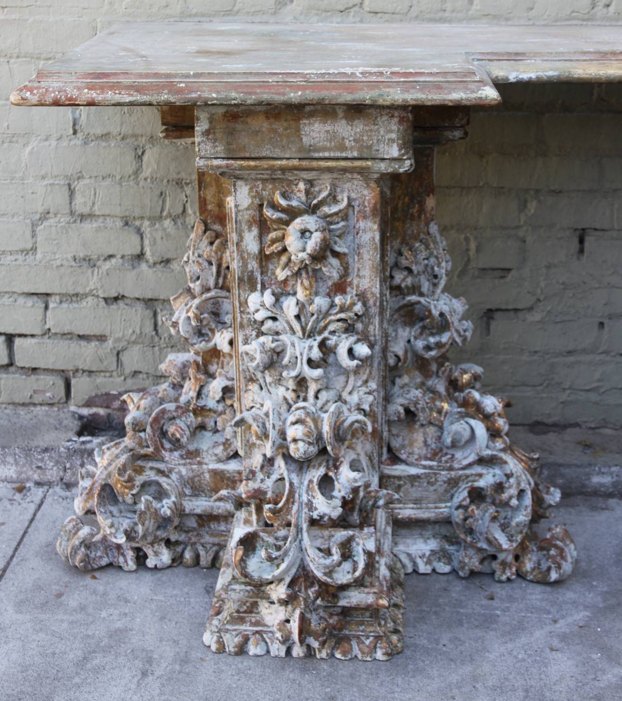 19th century Baroque style Italian painted and parcel gilt carved console table. Egg and dart wood carved base with acanthus leaves, scrolls, flowers and fruit throughout.