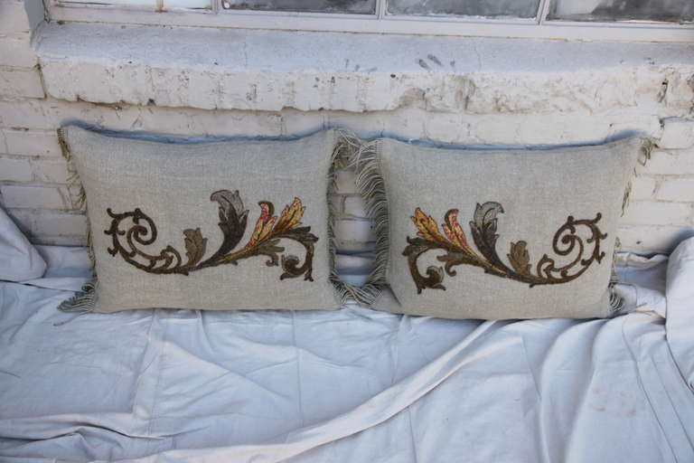 Pair of custom pillows made from hand embroidered acanthus leaves of  metallic, silk and chenille threads appliqued on Belgium linen with antique silver metallic fringe.  Down inserts. Sewn shut.