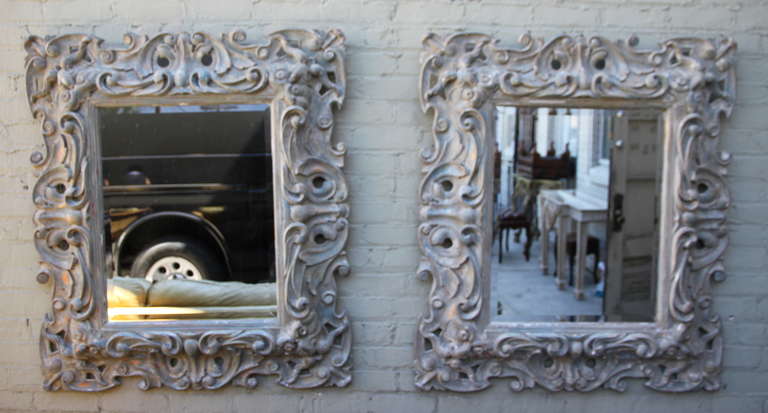 Pair of Italian Carved Mirrors w/ bevel detail.  The mirrors are painted in a soft grey coloration with gold highlights.