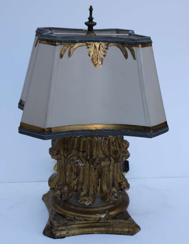 Pair of 19th century Italian capitals newly wired into lamps and crowned with hand-painted parchment shades. Measures: 8