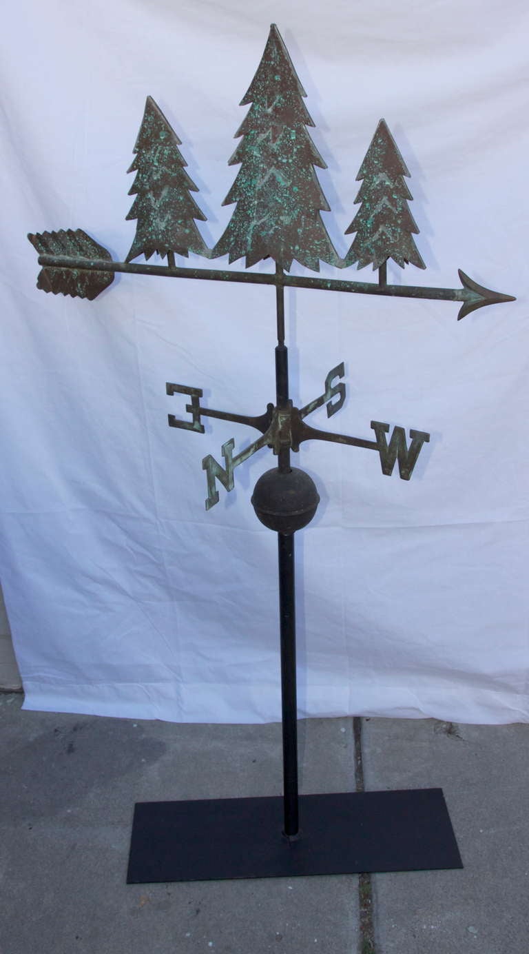 Rare copper pine tree hollow bodied weathervane with great undisturbed surface and original directionals. Stands on contemporary iron base.