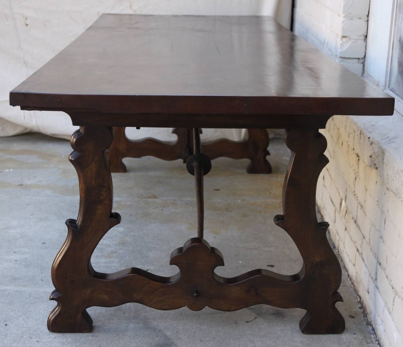 Spanish walnut dining table with iron stretchers.