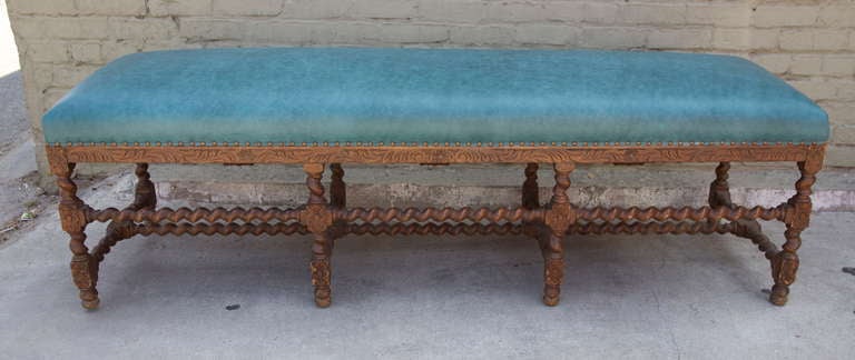 A Charles II style carved turquoise leather upholstered bench with self welt and spaced nailhead trim detail.