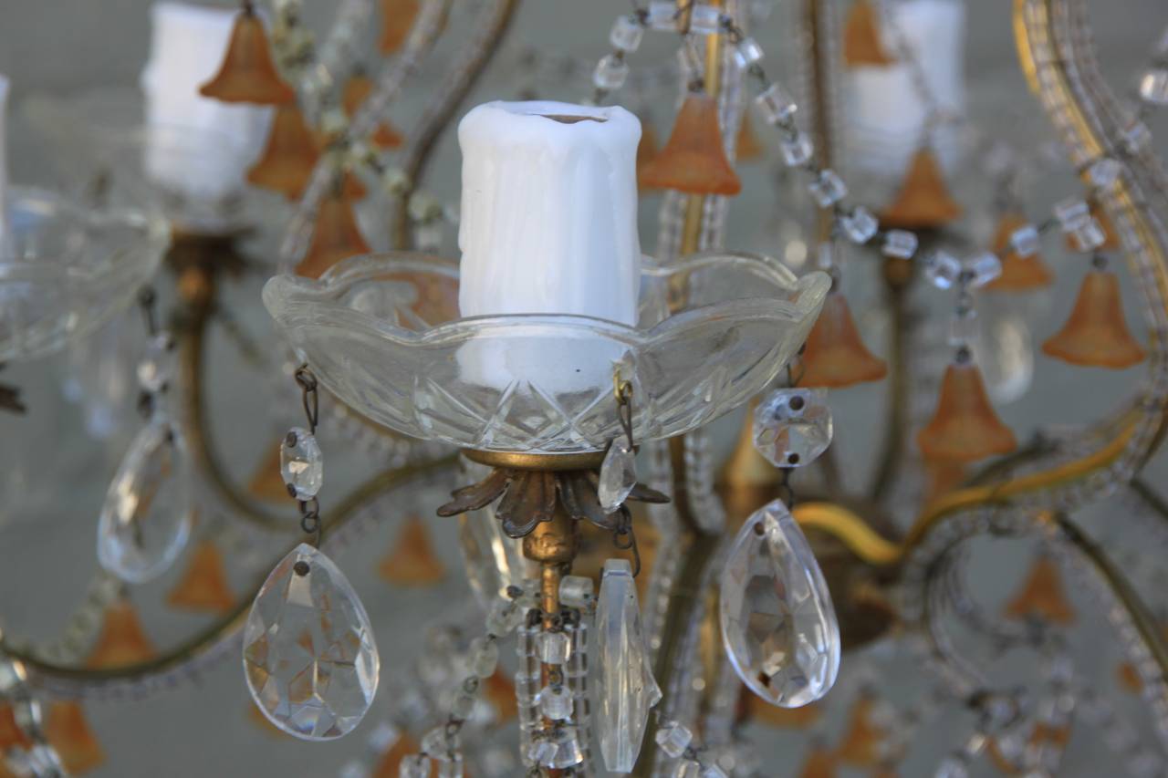 Six-light amber colored Murano glass chandelier with macaroni beaded garlands throughout.