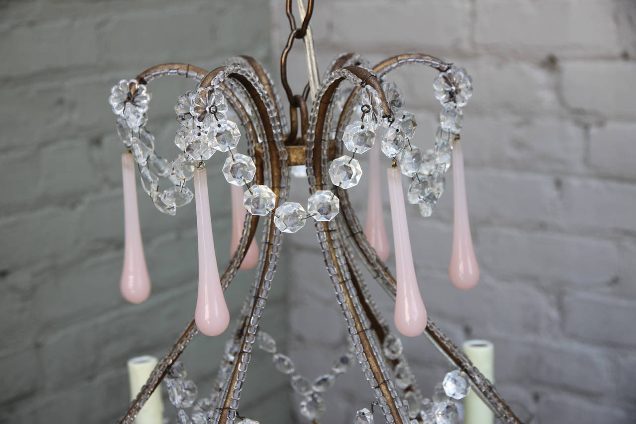 Eight-light Italian crystal beaded chandelier adorned with rare Murano pink opaline drops. Newly wired and in working condition with wax candle covers.