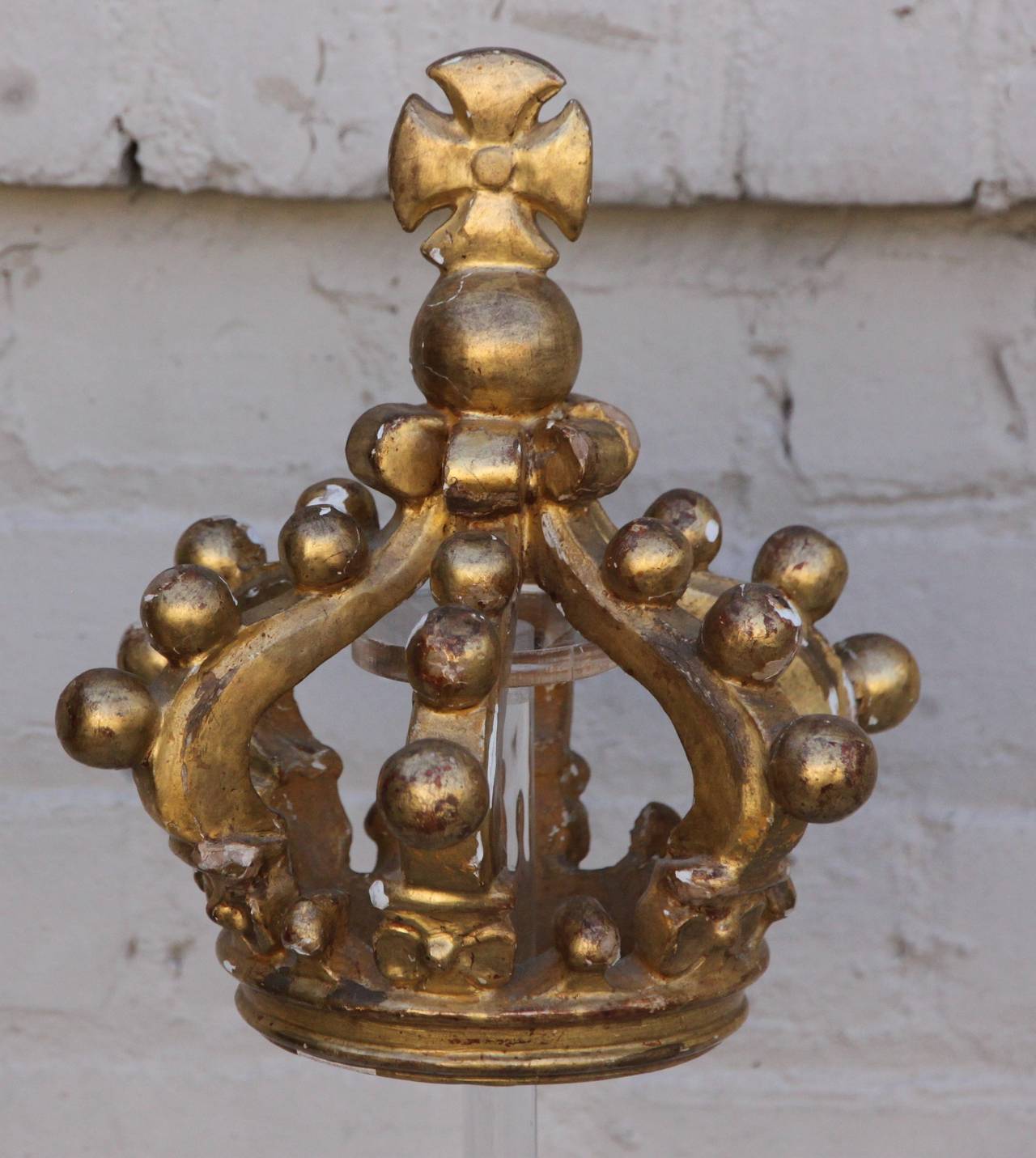19th century carved wood gold leaf crown floating on a lucite base.