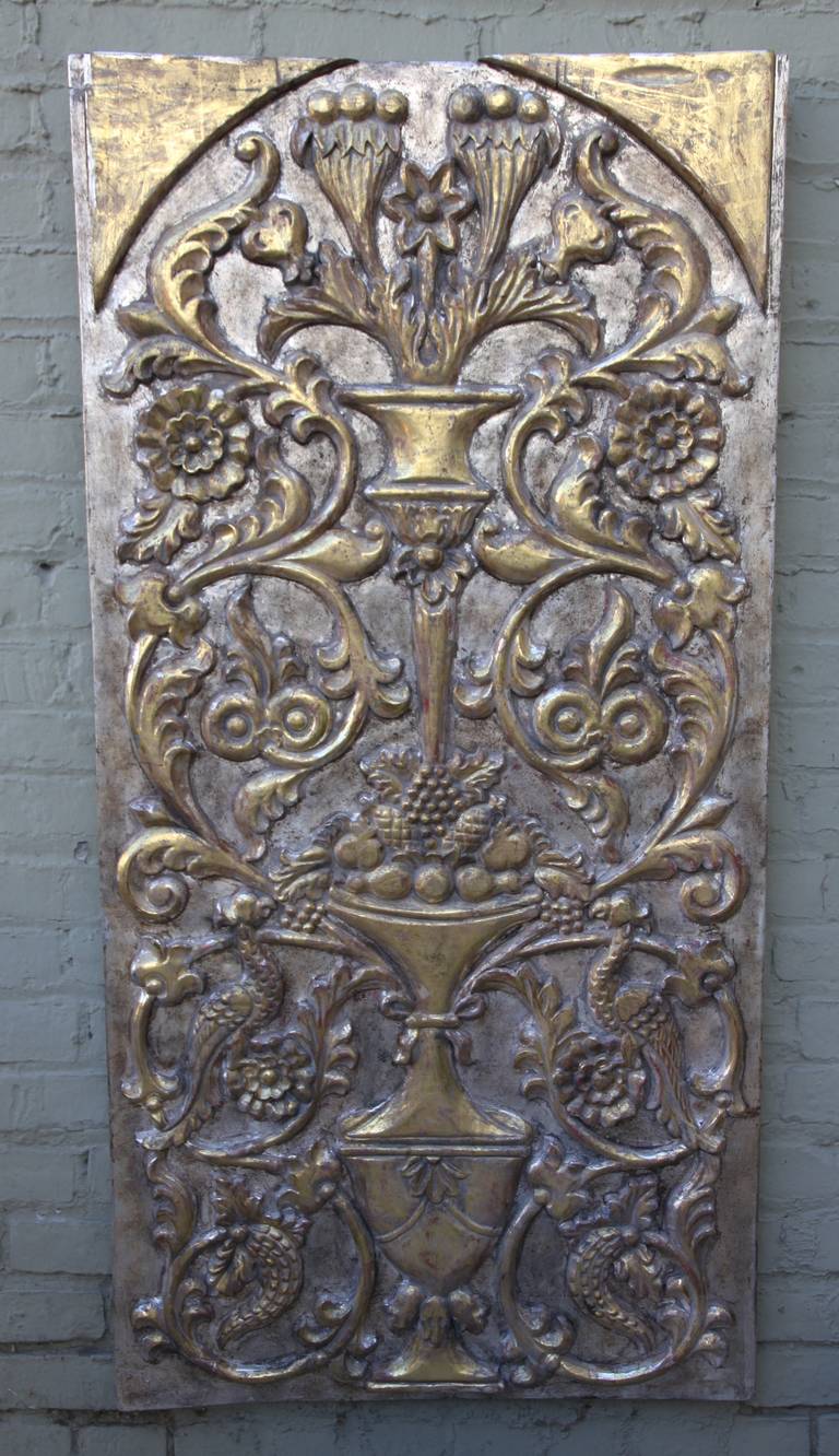 Italian carved silver and gold gilt wood panel with with a center urn filled with fruit and surrounded by scrolled acanthus leaves, birds, cornucopias and so much more detailed throughout.