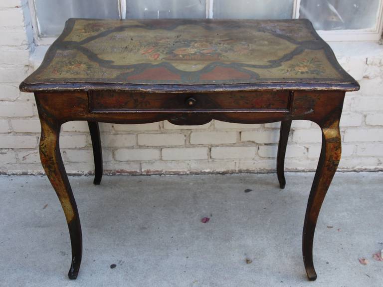 19th century French painted table standing on four cabriole legs with center drawer.