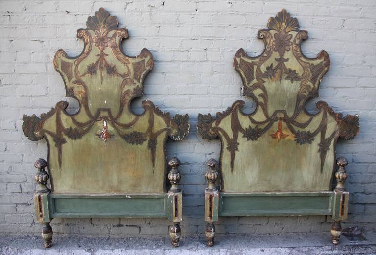 Pair of 19th century Italian painted twin-size headboards with swags and flowers throughout.