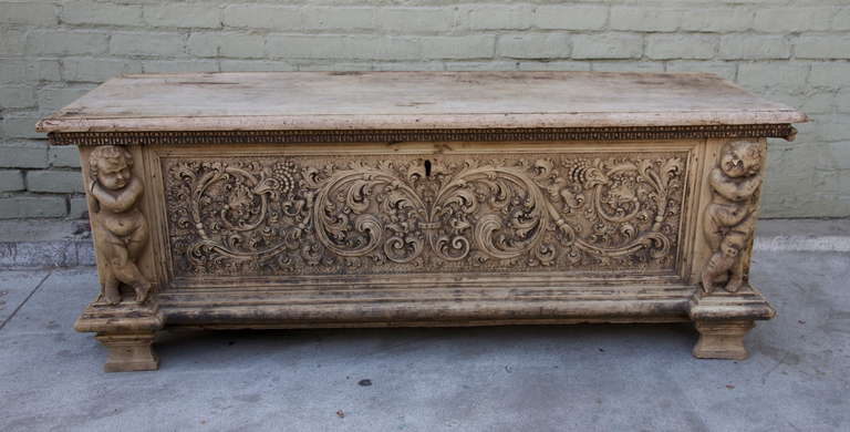 19th century Italian cassone with intricate carving throughout.  Original iron hardware.
