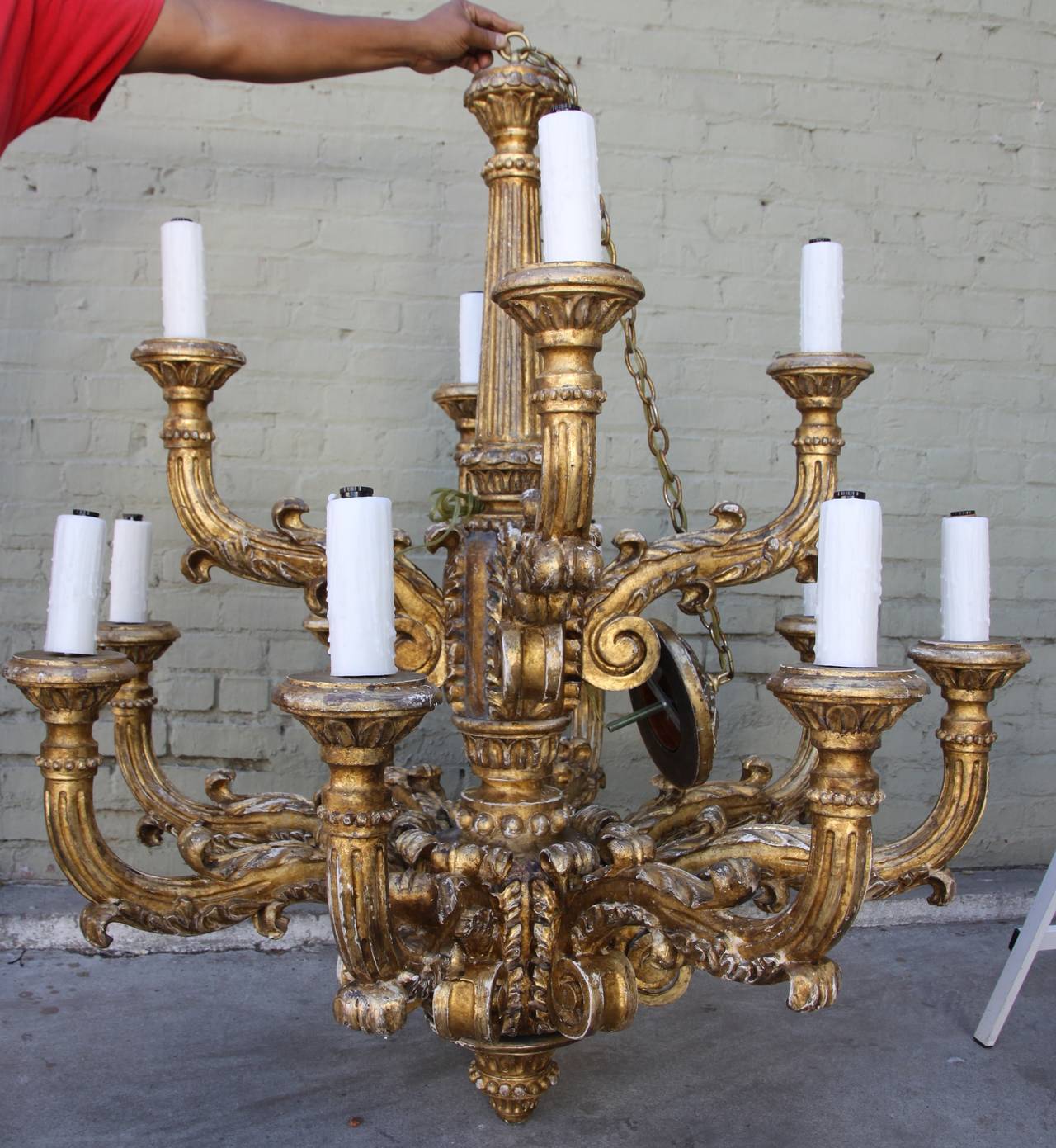 Monumental Italian fourteen-light two-tier giltwood chandelier. Newly wired with wax candle covers.