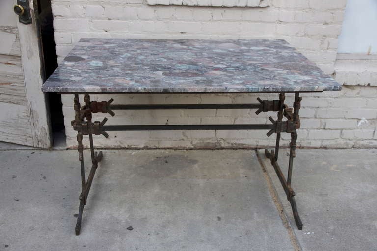 French wrought iron & marble bistro table. The marble has stunning shades of lavender, pink, blue, grey, & rust.