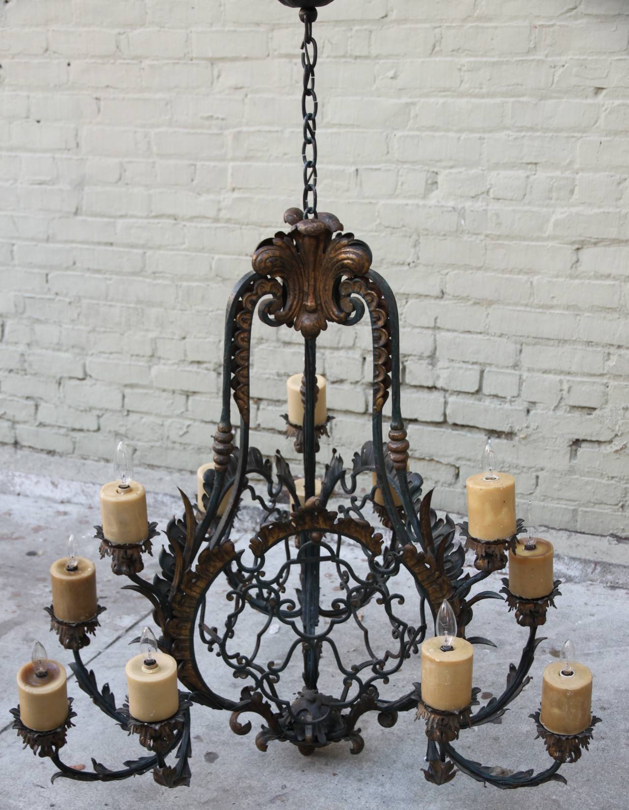 Spanish twelve-light wrought iron painted & gilt metal chandelier. Newly wired with wax candle covers.  