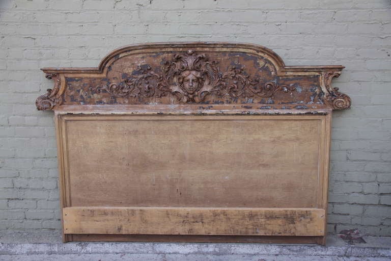 Italian carved headboard with distressed finish. Carved face with acanthus leaves throughout.