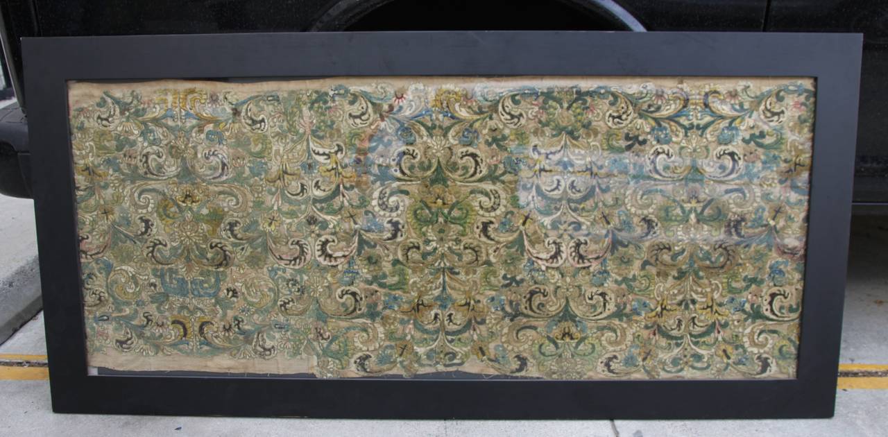 18th century framed Italian embroidered textile in a black wood painted frame.