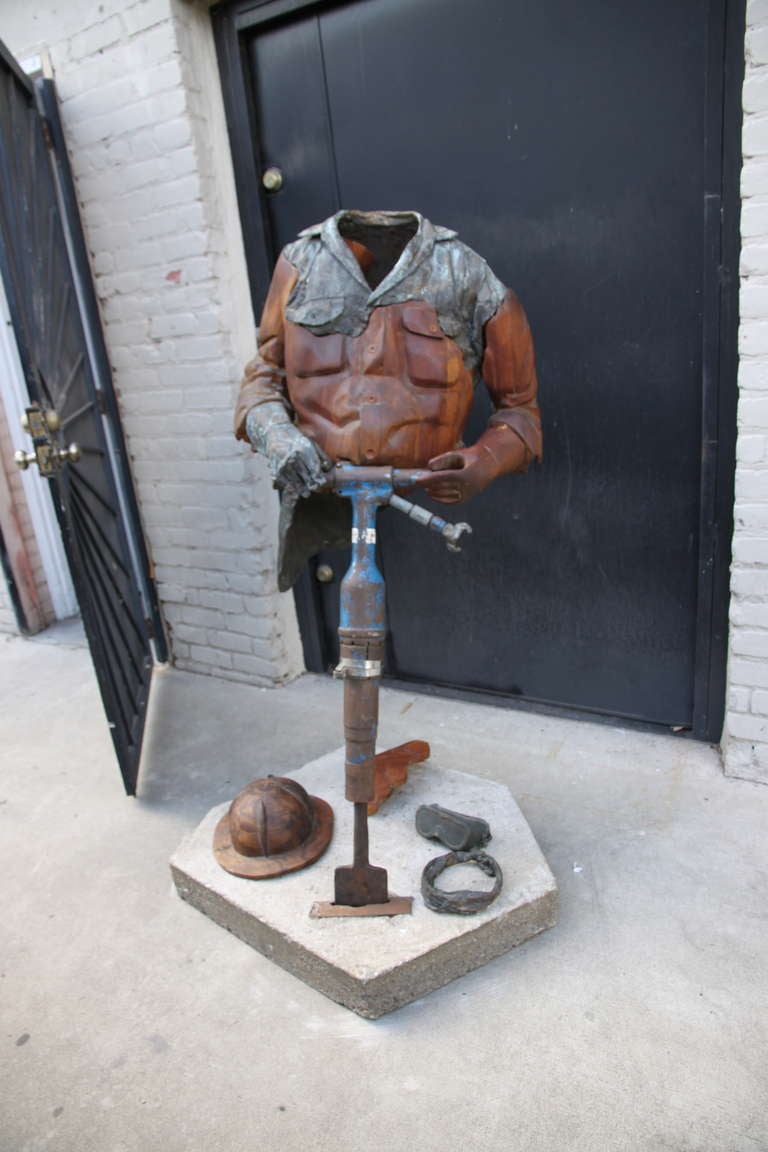 The Jackhammer mixed media (bronze, iron, wood, cement) by Steve Linn.  Bold and striking, this large piece demonstates Linn's unique style in Modern Realism.  Linn's works have been exhibited in museums across the United States and Europe.  This