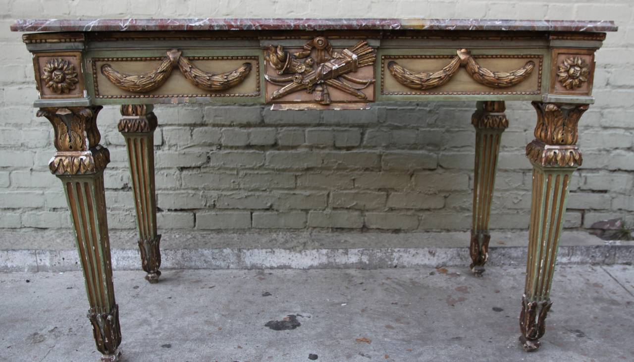 19th century French Louis XVI style painted and parcel-gilt console with Breccia marble top. Soft painted apron with carved giltwood garlands and giltwood rosettes. Stands on four straight fluted legs.