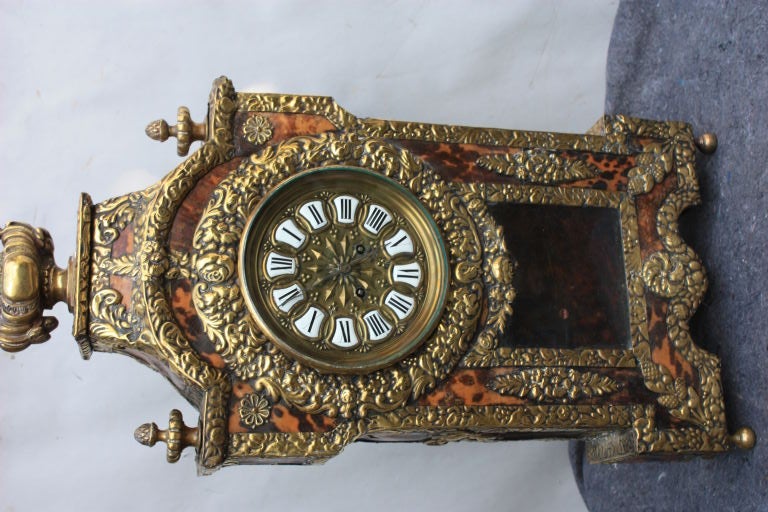 I like this for the fact it not like all the Boulle clocks around and has a rustic feel.Pleasing translucent color on the laminate shell.Original high grade bronze movement.
