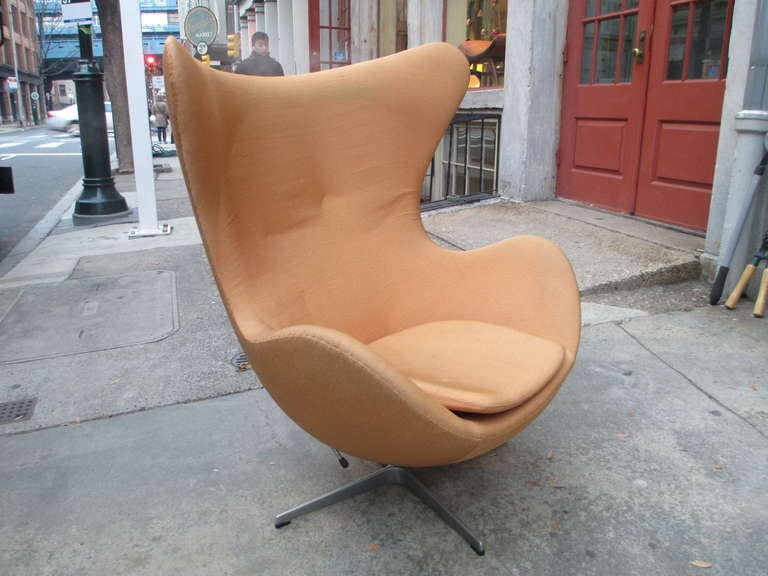 Arne Jacobsen Reclining Egg Chair in a pale orange fabric.  Slightly soiled and faded but serviceable.  Reupholstering cost are  850.00 in your fabric.  Reclining feature is a great option not often seen!  Retains original label.