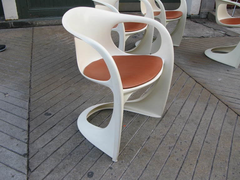 Nice set of 70's Alexander Begge Stacking chairs produced in the early 70's for Casala.  Fiberglass construction with small thin upholstered seats.
