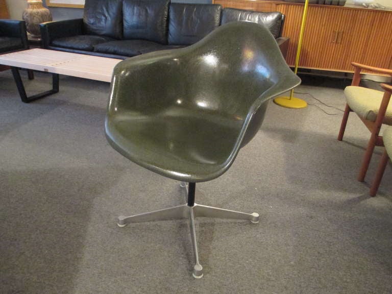 Charcoal gray Eames armed shell on four star swivel base of aluminum.  Formerly property of IBM as label shows.  Also retains Herman Miller label.  Shell is in incredible condition with all the shine it had originally.  Its only flaw is a 1 quarter
