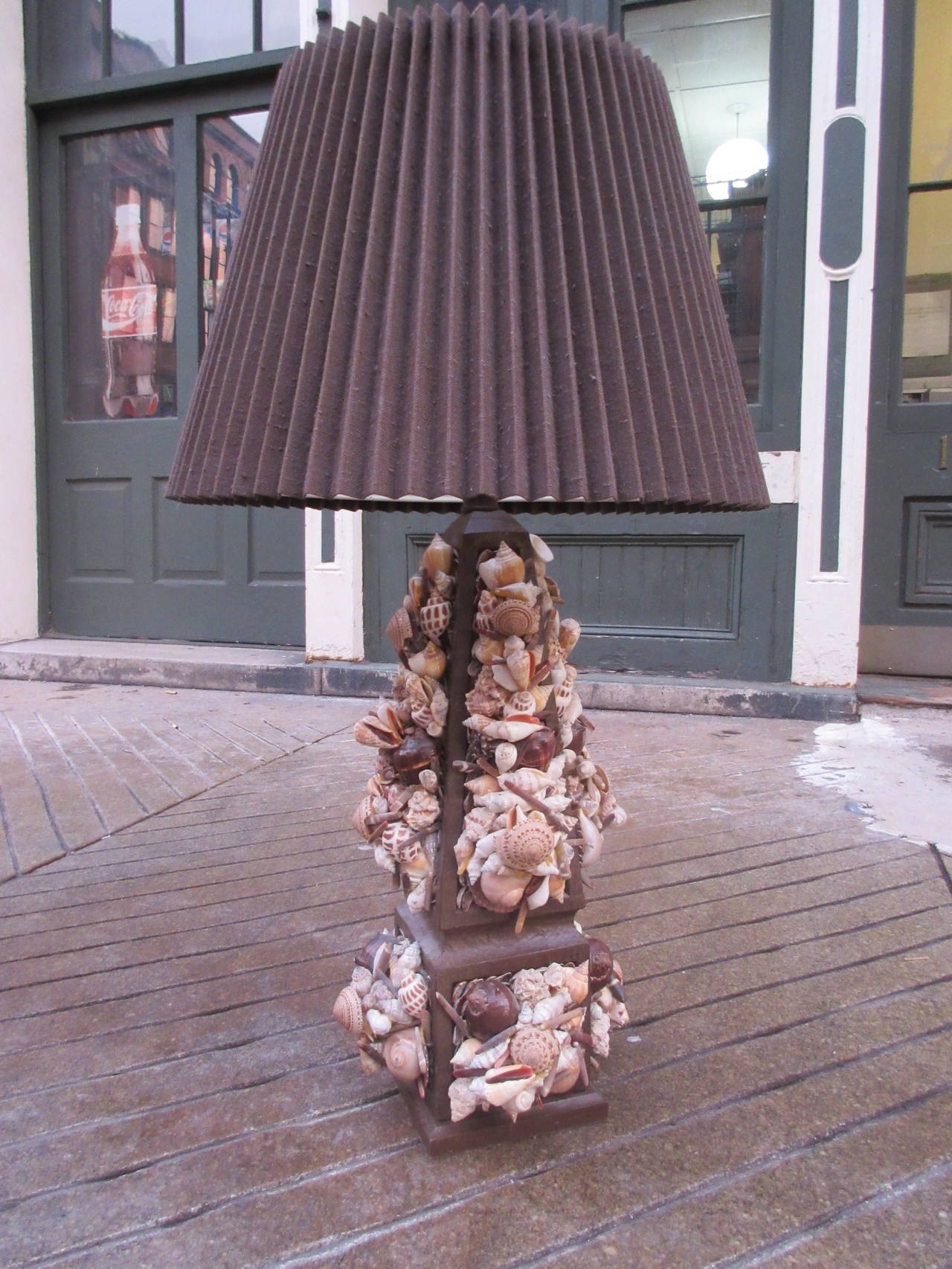 Large 1970s seashell lamp made up of 100's of different shells mounted on a wood column.