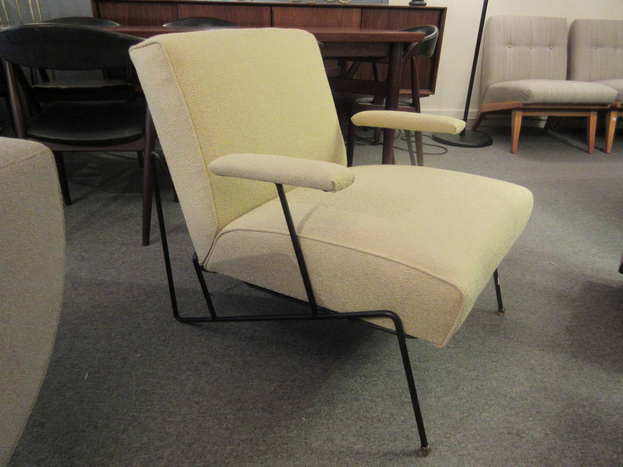 Comfortable armchair reupholstered in a celery colored weave. Chair retains original plastic spherical ball feet capping the angular wrought iron frame.
