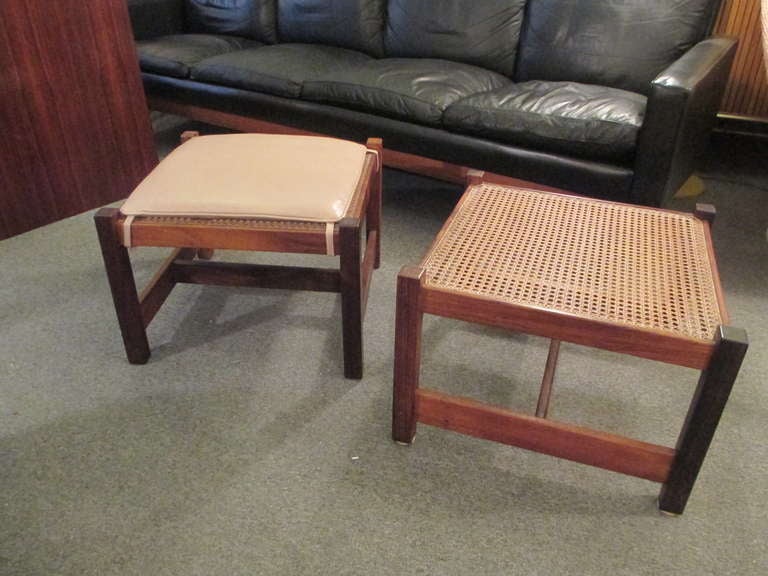 Beautiful Rosewood ottomans with leather cushions.  These hand-caned ottomans show beautiful nicely grained solid rosewood.  The caning on these Danish stools has been redone using hand woven caning not premade. The leather cushions in tan are new.