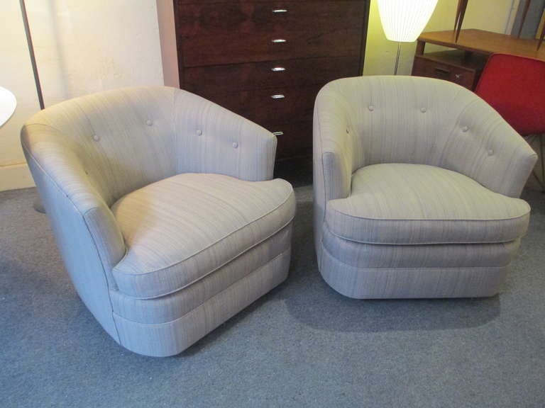 Newly upholstered pair of 70's barrel chairs with a slight squared off back which gives these chairs a slight twist on a classic design!  Fabric is wool blend in shades of cream, olive and light browns.