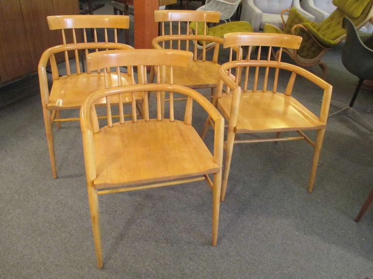 Solid Birch captains chairs by Paul McCobb for Winchendon retaining labels. These handsome chairs have a shovel seat with arched back rest.  Beautifully refinished.