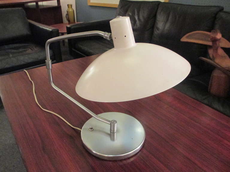 Rare desk lamp distributed by Knoll Associates.  Pictured in 1954 Knoll Cateloque.   Has multiple position joints.  Original paint and brushed steel base and support.