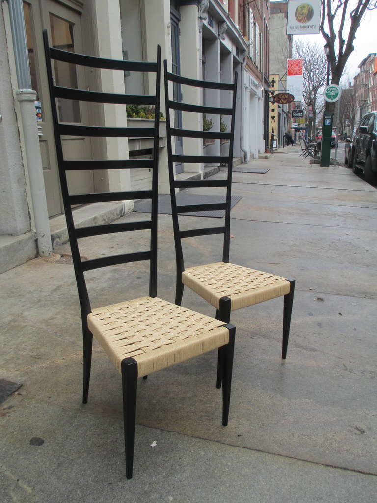 Two Gio Ponti inspired Italian 1950s ladder-back chairs.  Both retain original decal label and rewoven seat.   Somewhat based on Gio Ponti's remarkably light Superleggera chair.