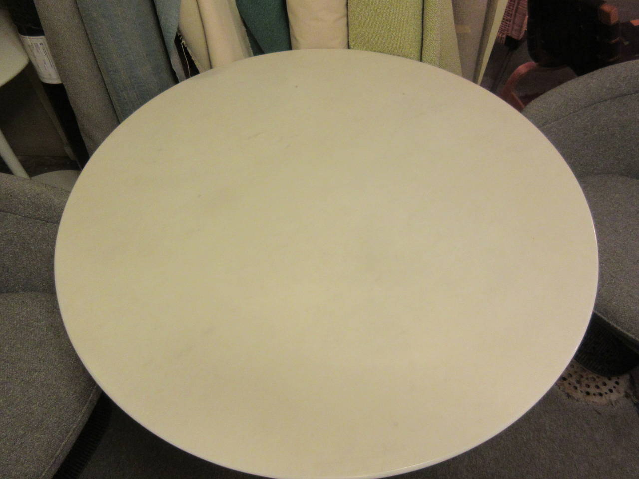 Dining table 42 inches in diameter with cast aluminum base by Knoll marble is white with very faint marbling of gray. Base is pure white.